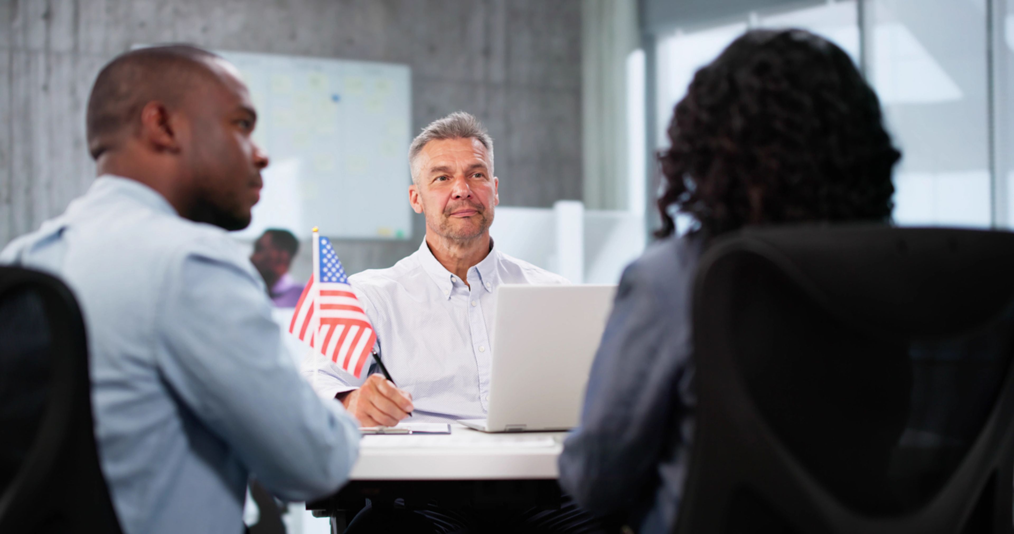 Immigration officer interviewing couple for their Green Card application.