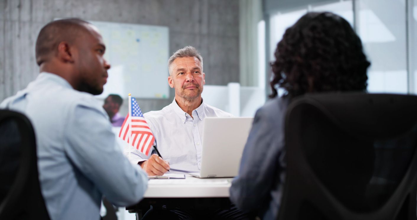 Immigration officer interviewing couple for their Green Card application.
