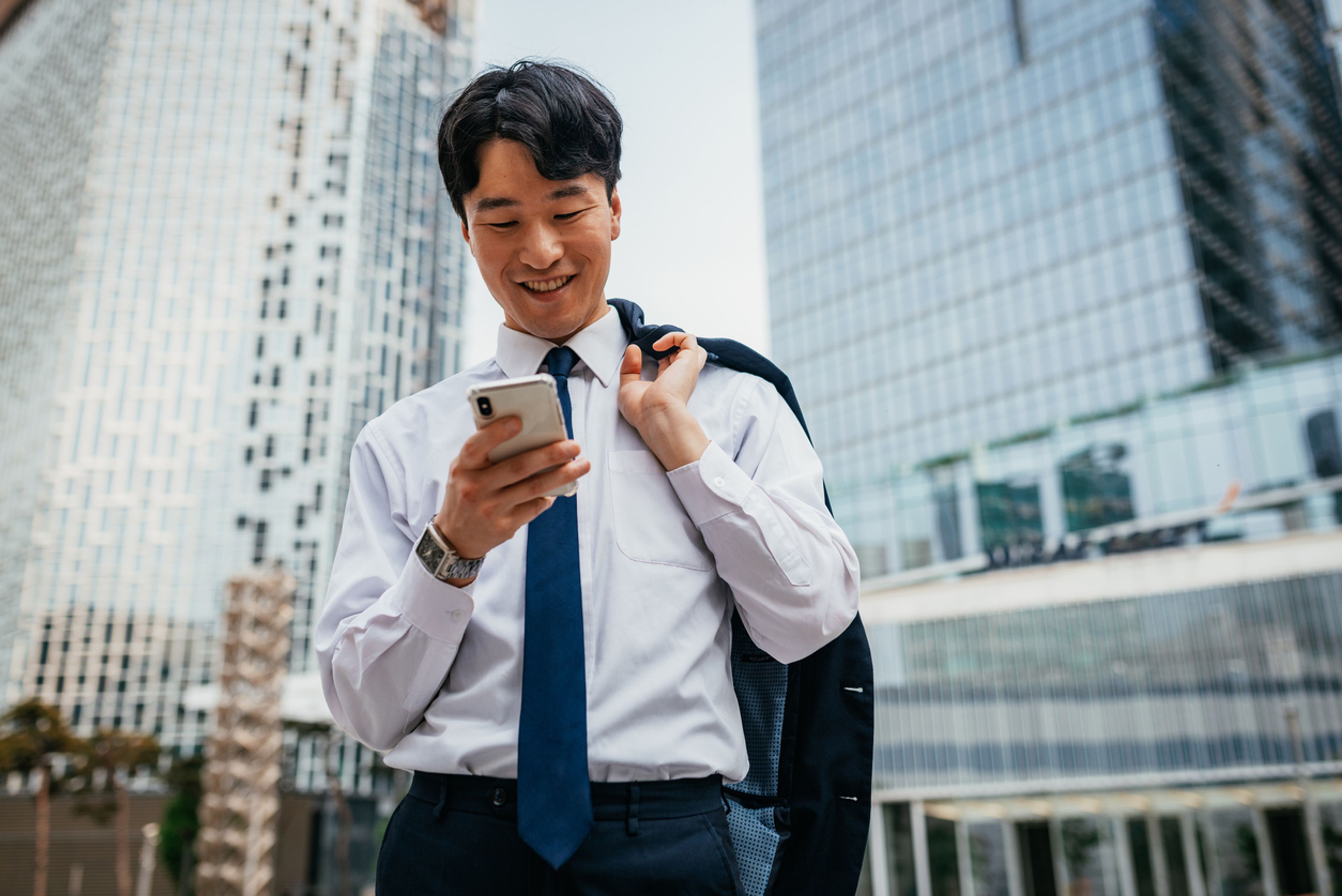 South Korean founder checking his phone in Seoul