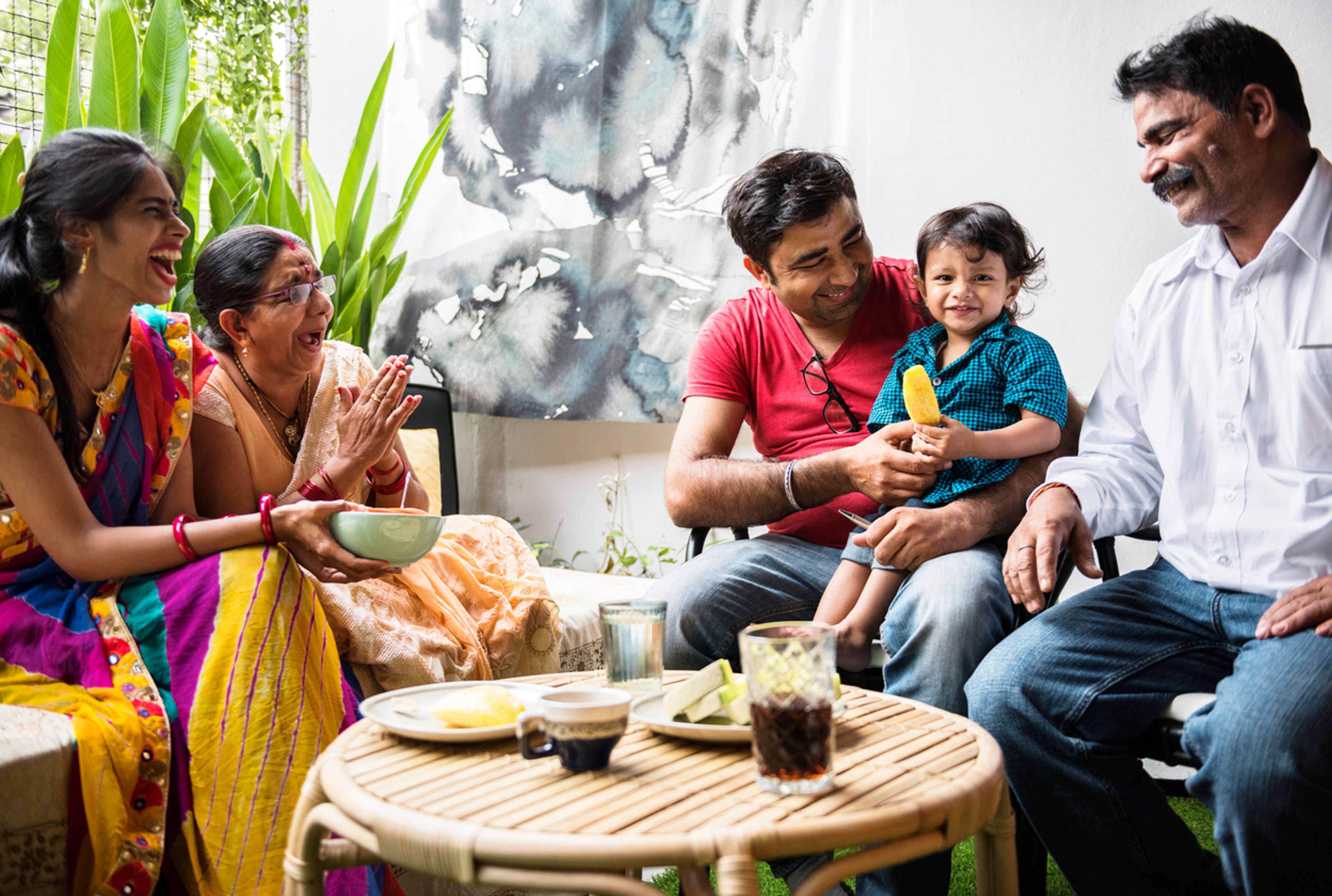 Happy Indian family comprising multiple generations.