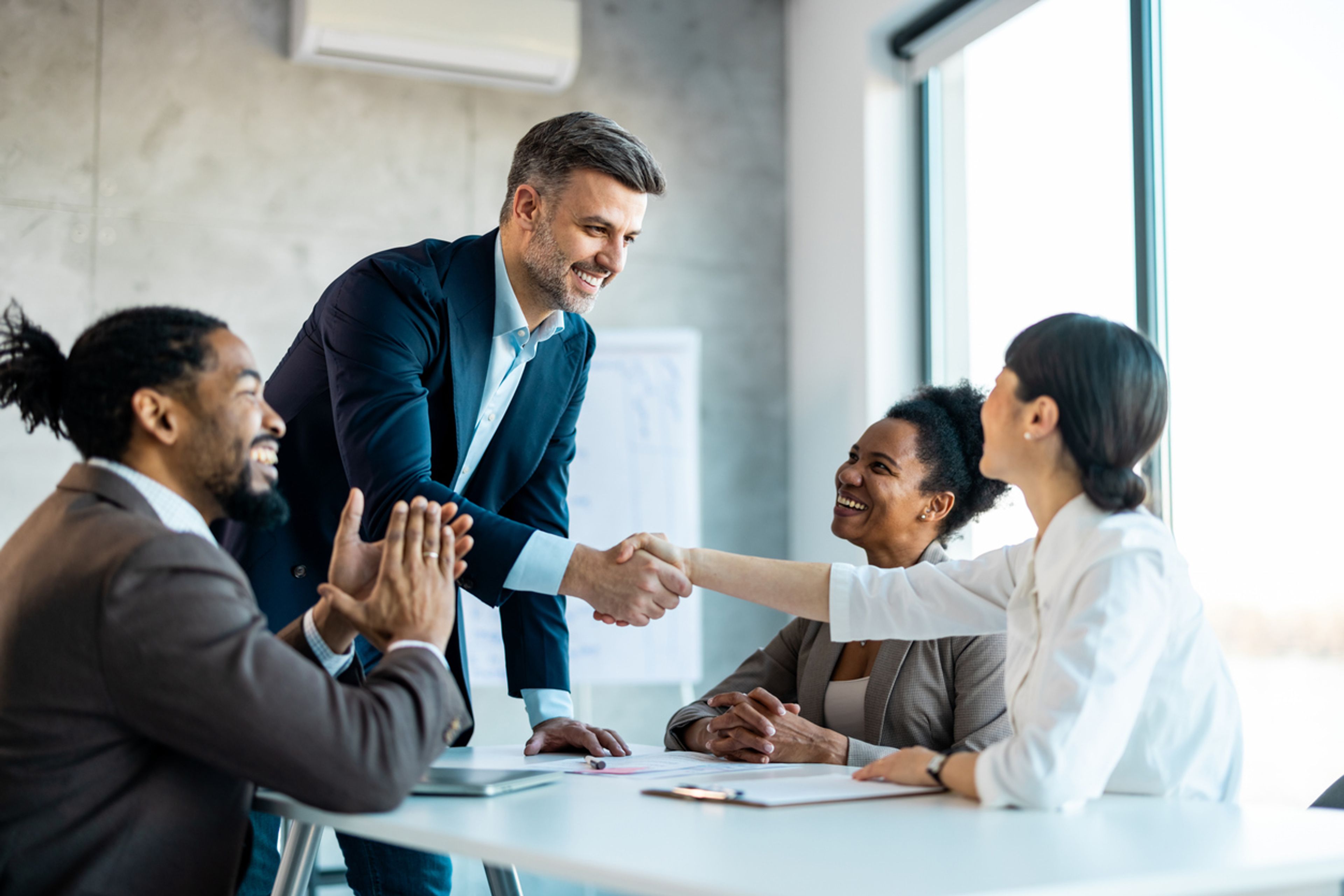 Investor shaking hands after closing a deal.