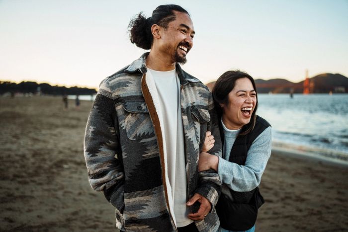 Happy Filipino couple together on the beach