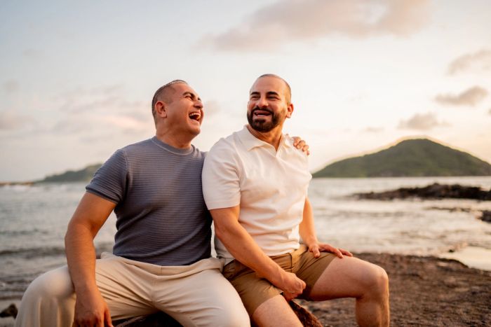 Married couple sitting together on the beach