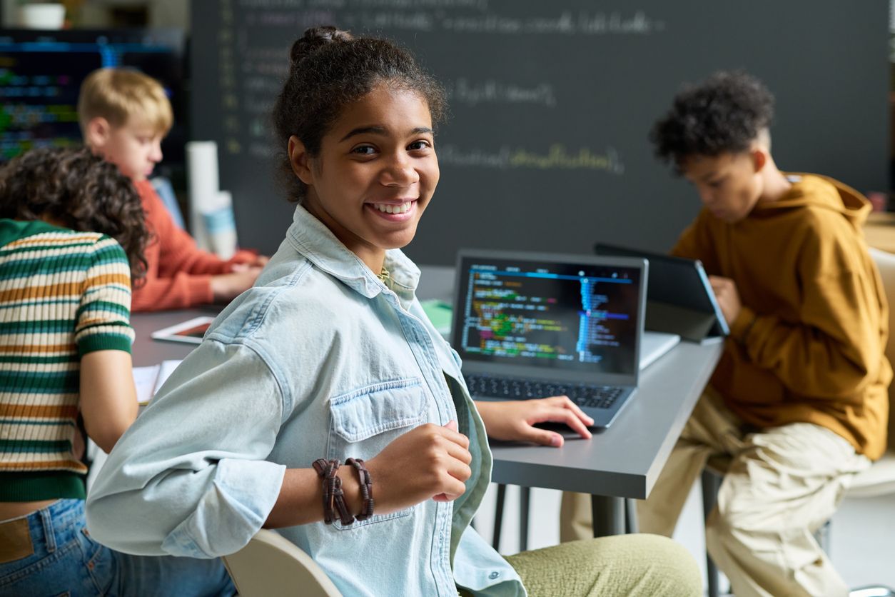 Student in class learning how to code.
