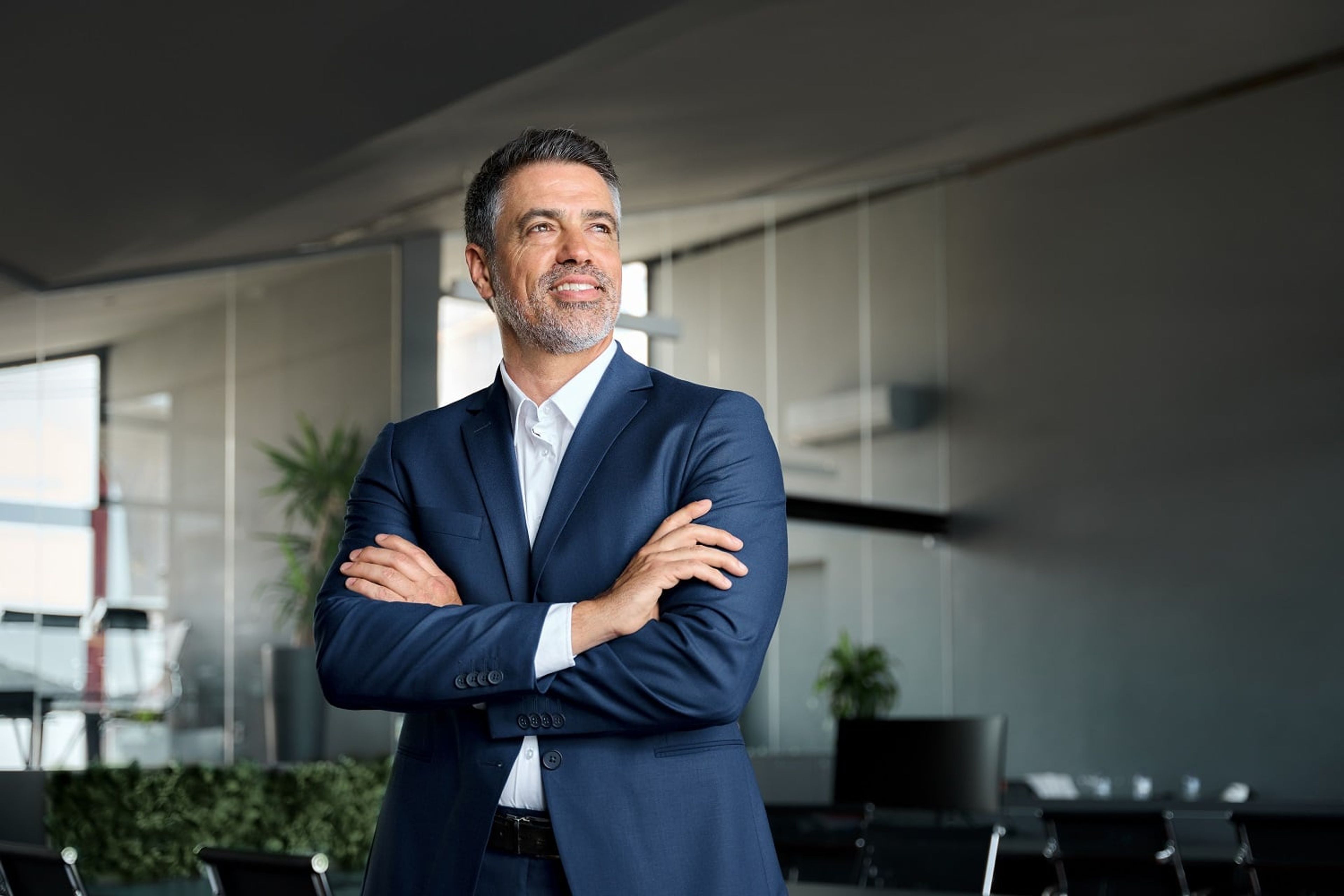 Businessman in blue suit with his arms crossed