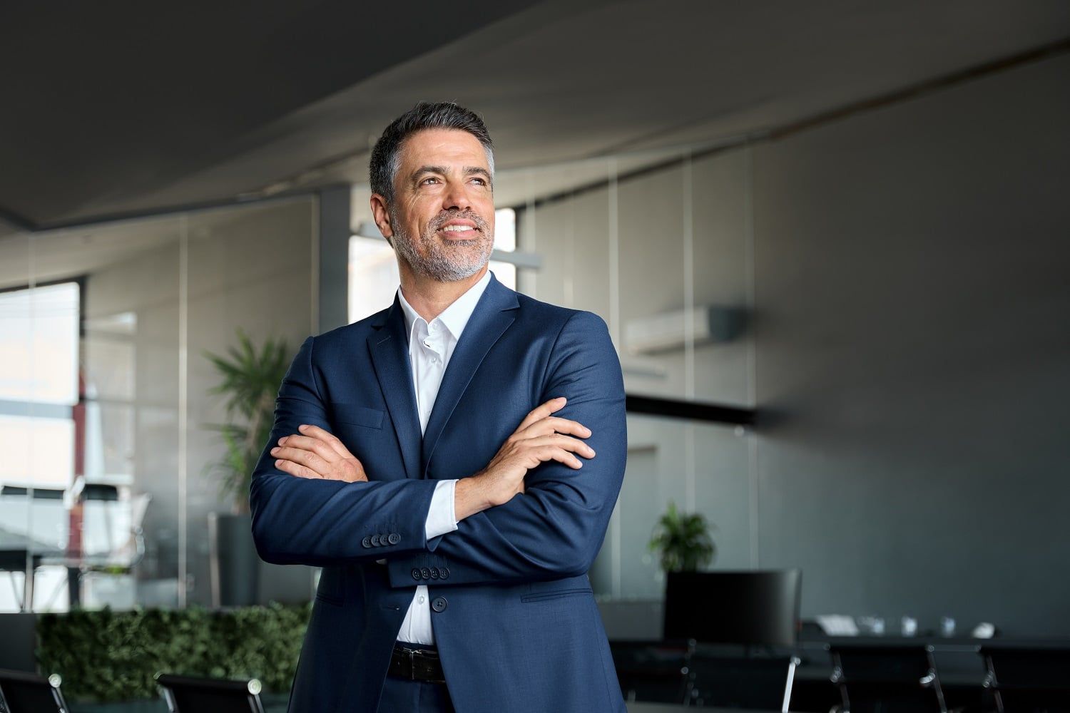 Businessman in blue suit with his arms crossed
