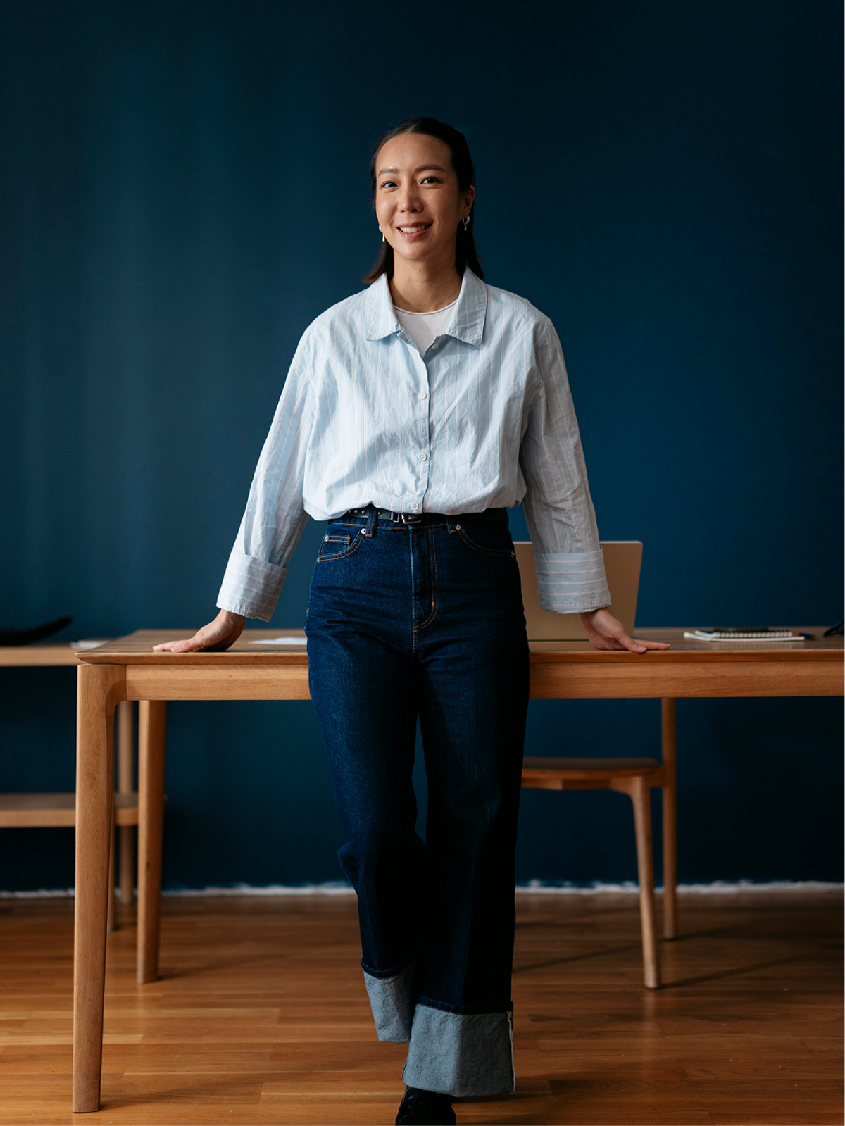 A founder standing confidently by a desk in an office