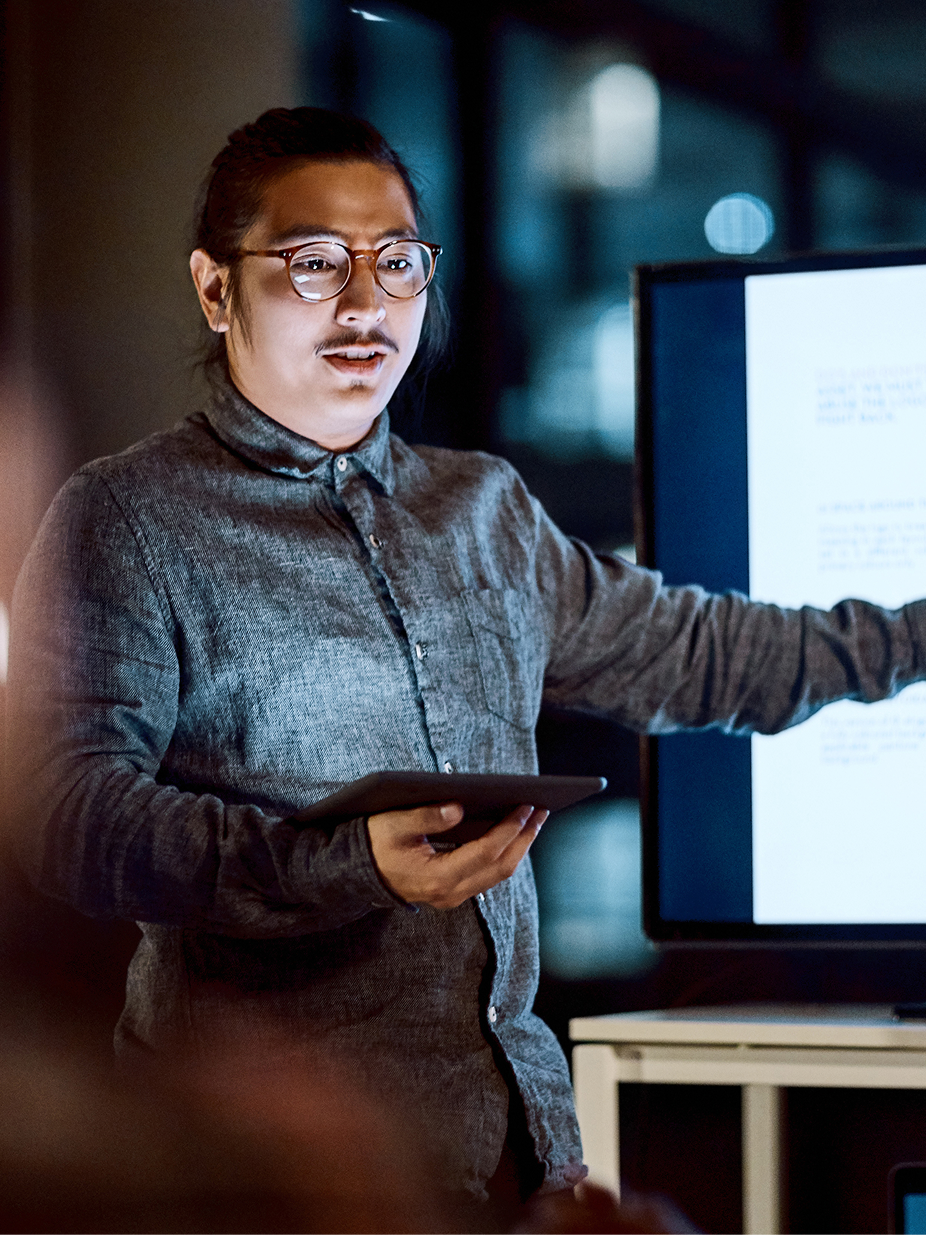 An engineer presenting technical work on a screen