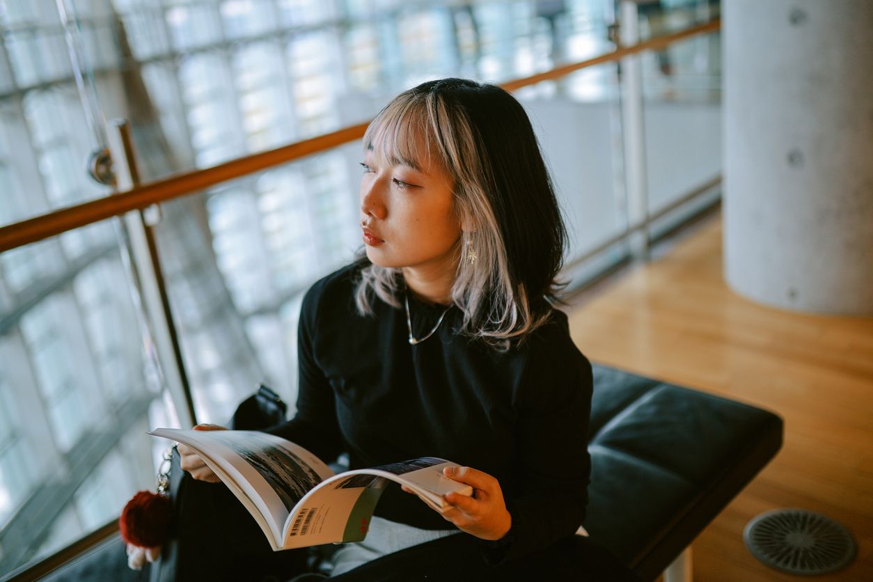 An international student overlooks her university library, during the Duration of Status Final Rule