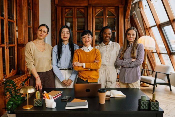 Startup founder standing together with employees.