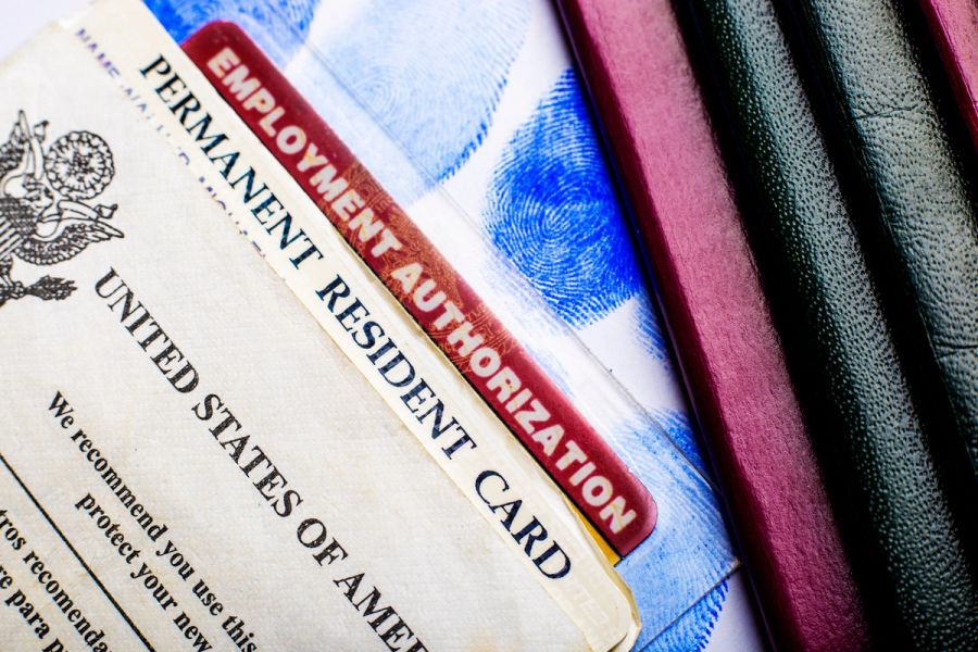 A closeup of a U.S. permanent resident card and an Employment Authorization Card