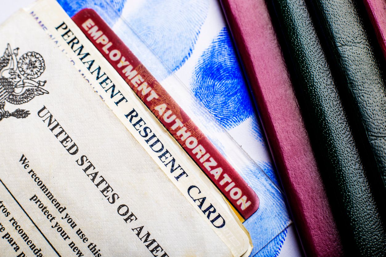 A closeup of a U.S. permanent resident card and an Employment Authorization Card