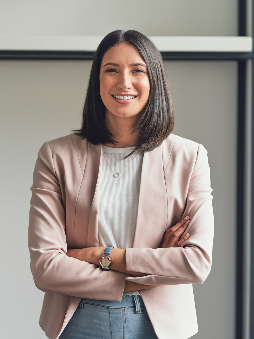 A founder standing with arms crossed in a modern office
