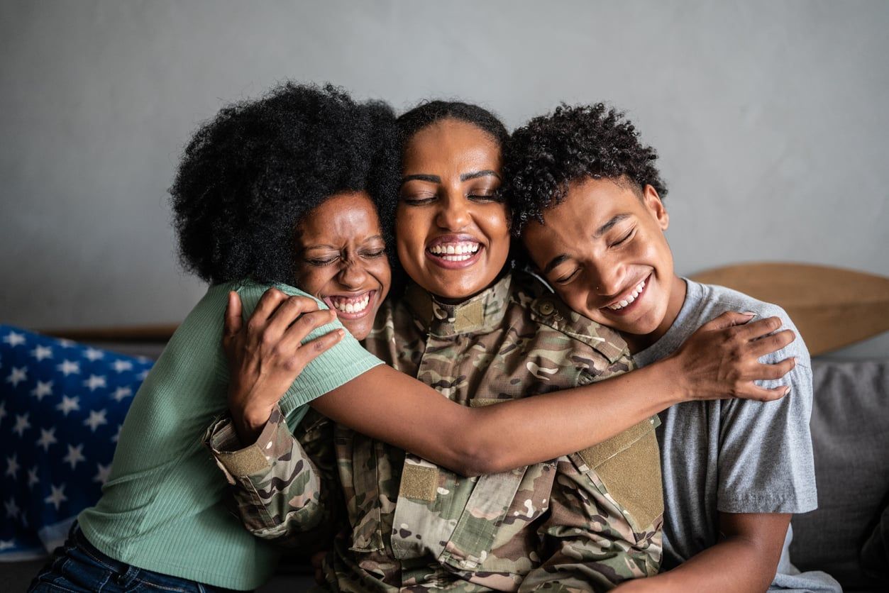 Smiling happy family hugging each other on their couch.