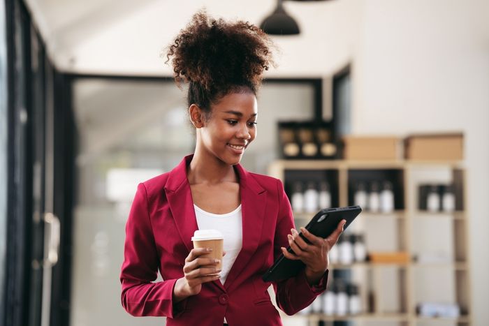 Woman in modern office looking at her tablet device.