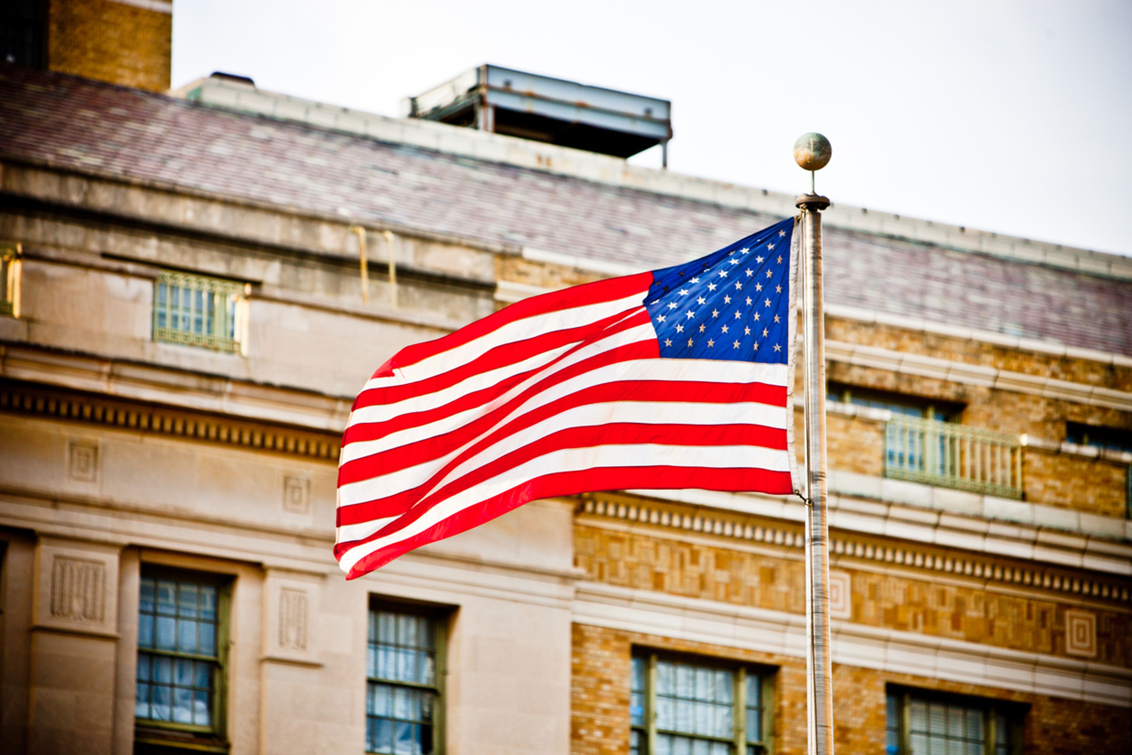 Closed U.S. embassy gate representing paused consular visa services