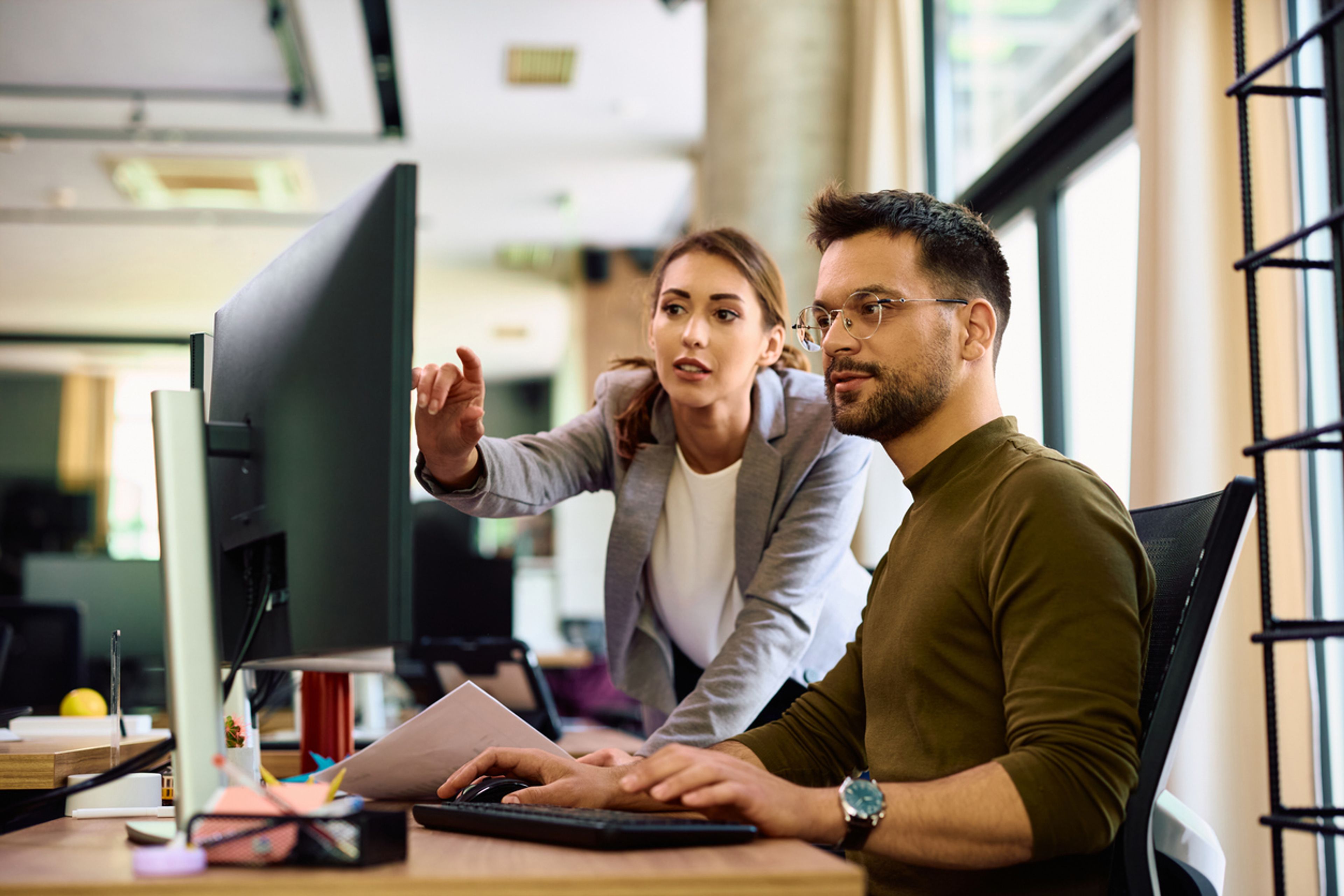 HR manager reviewing payroll data affected by DOL's prevailing wage increases