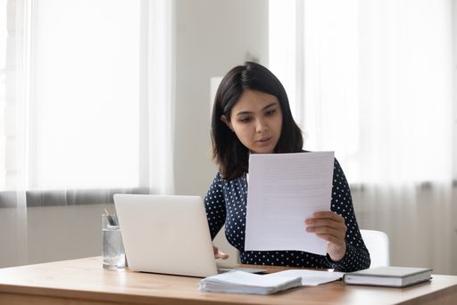 Woman reviewing Form I-912 fee waiver paperwork