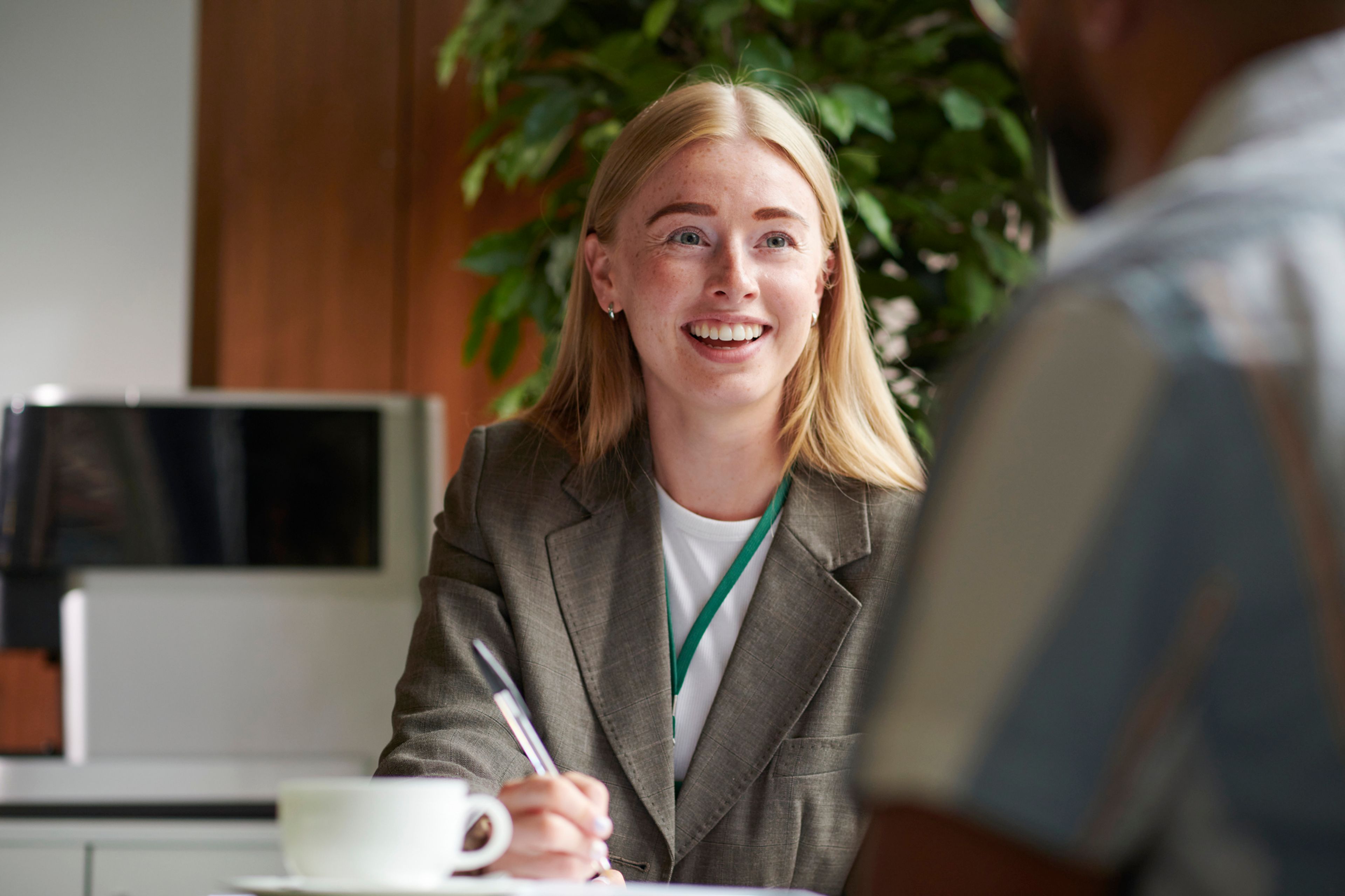 An adviser reviewing paperwork with an applicant across a desk.