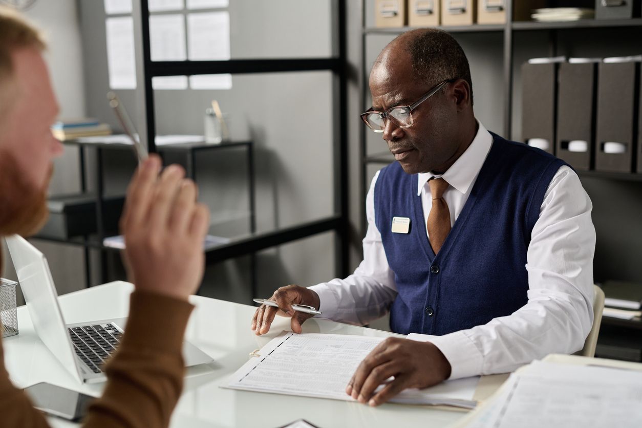 attorney works with client looking at legal documents