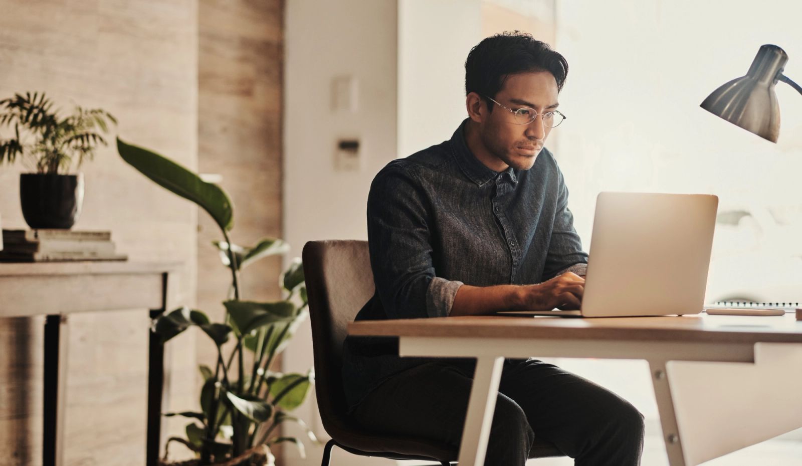 Man researching his immigration case on a laptop at a desk