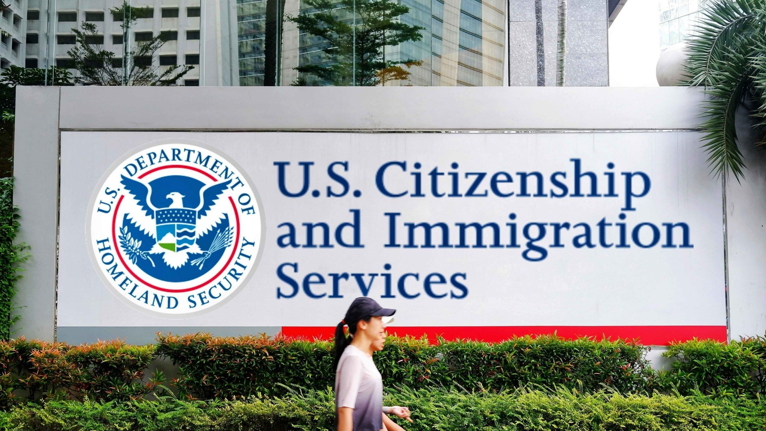 Woman walking outside a USCIS office building