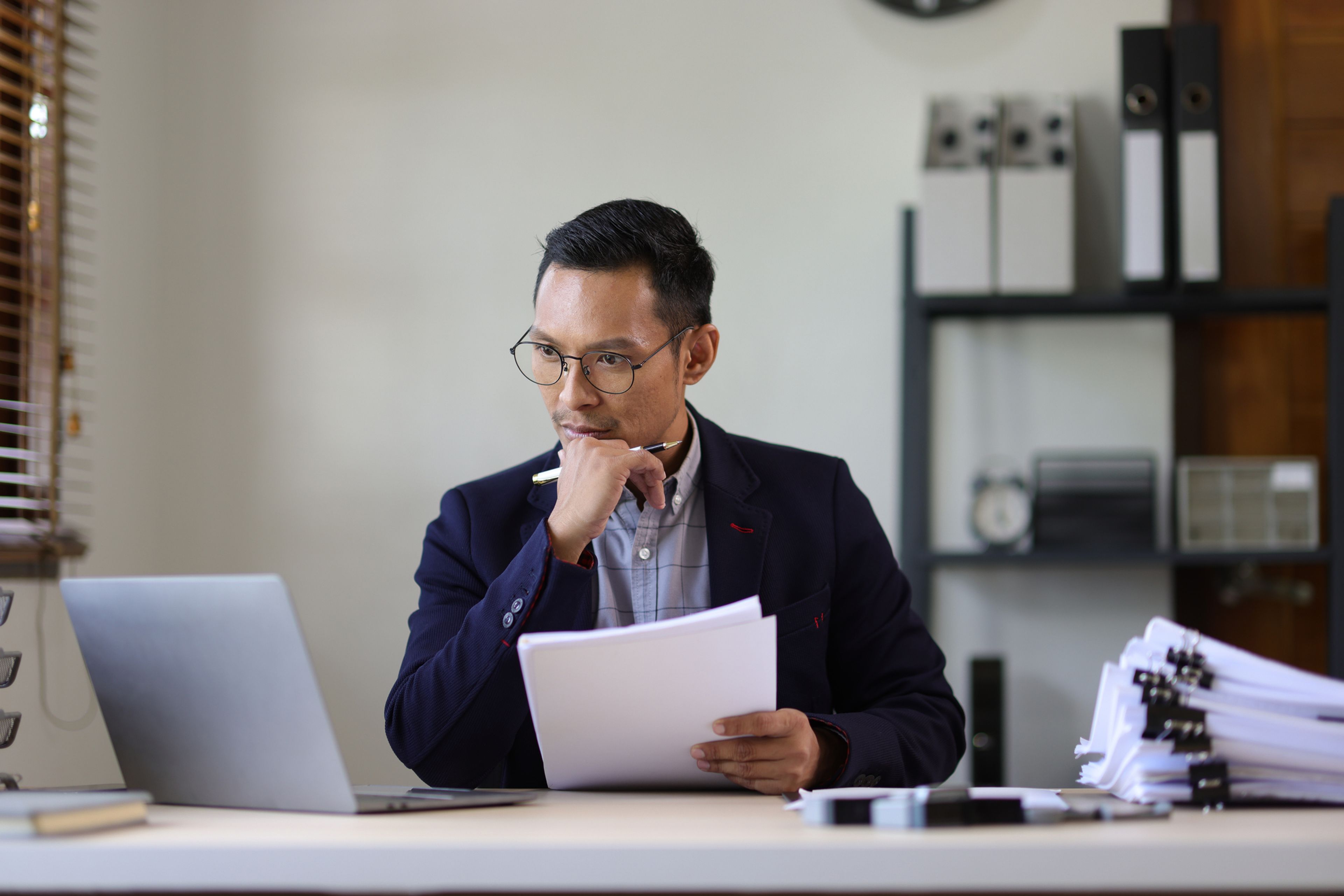 Businessman is busy with paperwork on the table in the office.