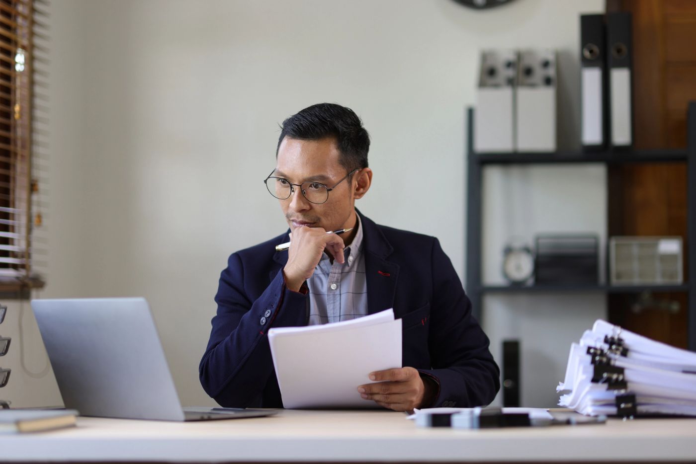 Businessman is busy with paperwork on the table in the office.