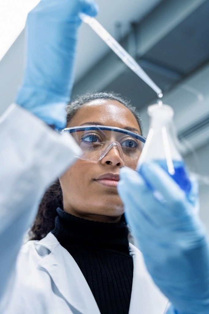 Researcher conducting laboratory work with a pipette