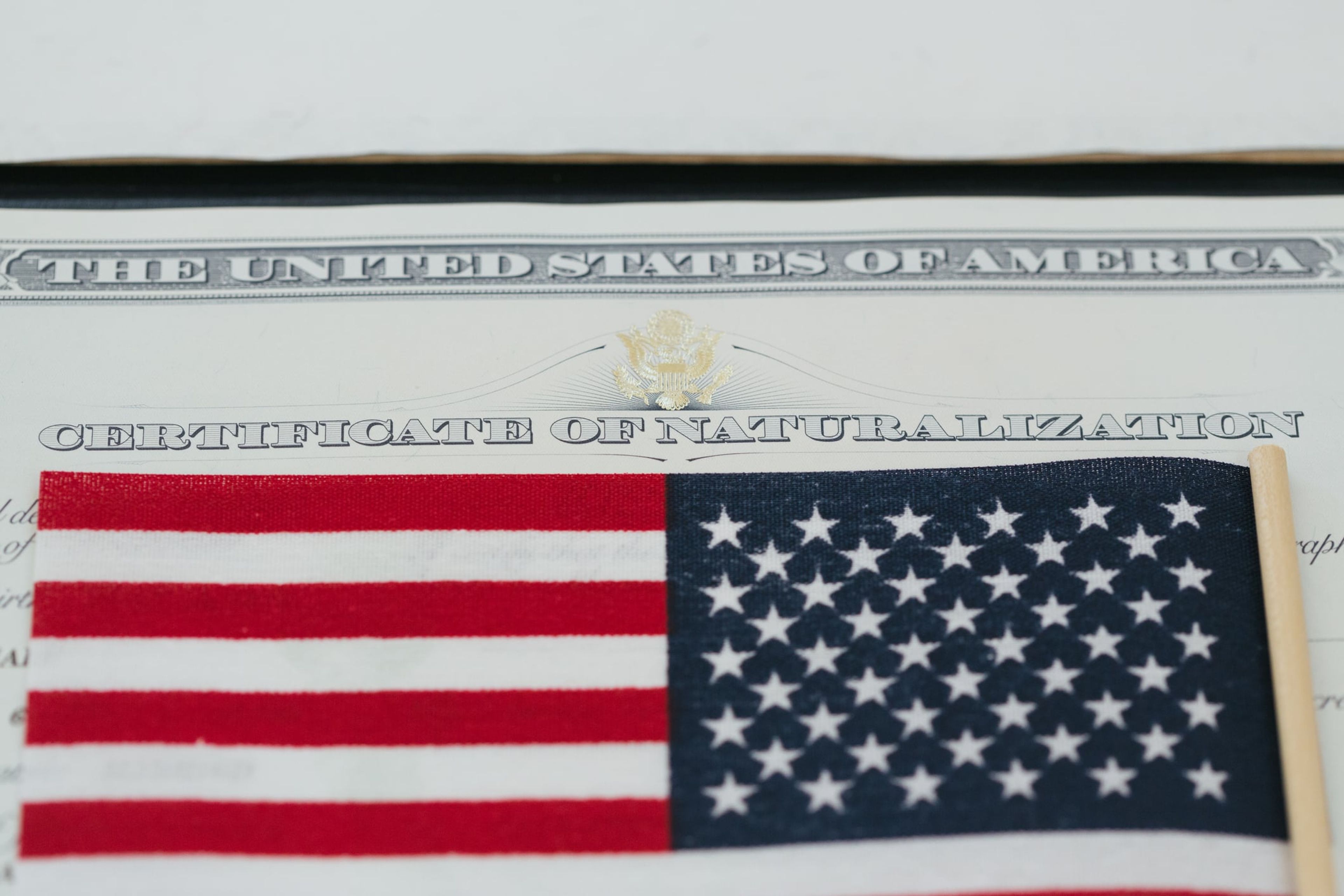 Close up of a Certificate of Naturalization and U.S. flag