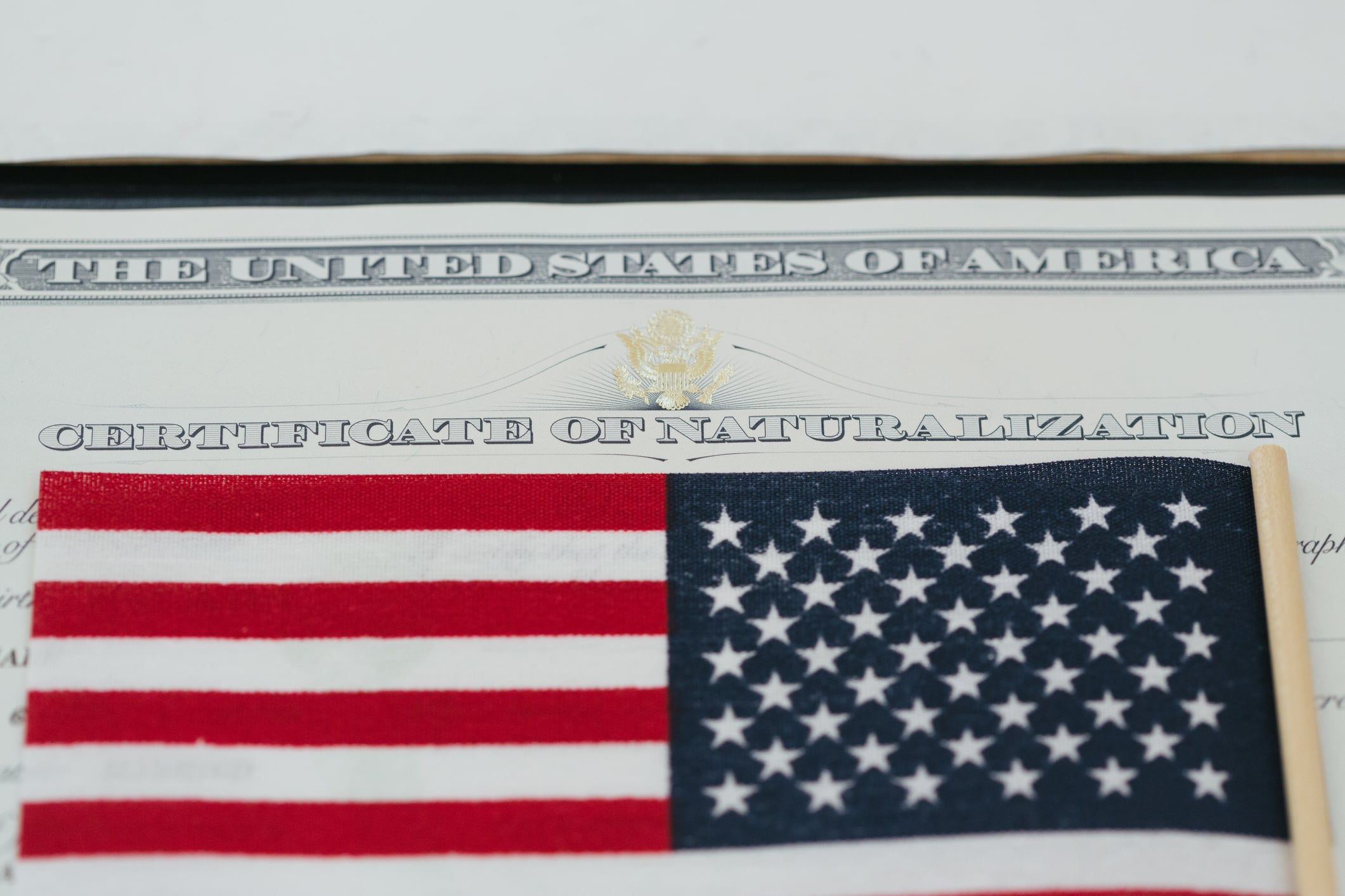 Close up of a Certificate of Naturalization and U.S. flag