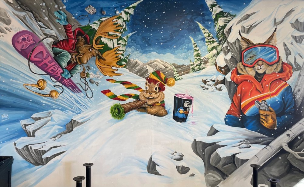 Mural of a moose, squirrel and rabbit lighting up on a ski mountain