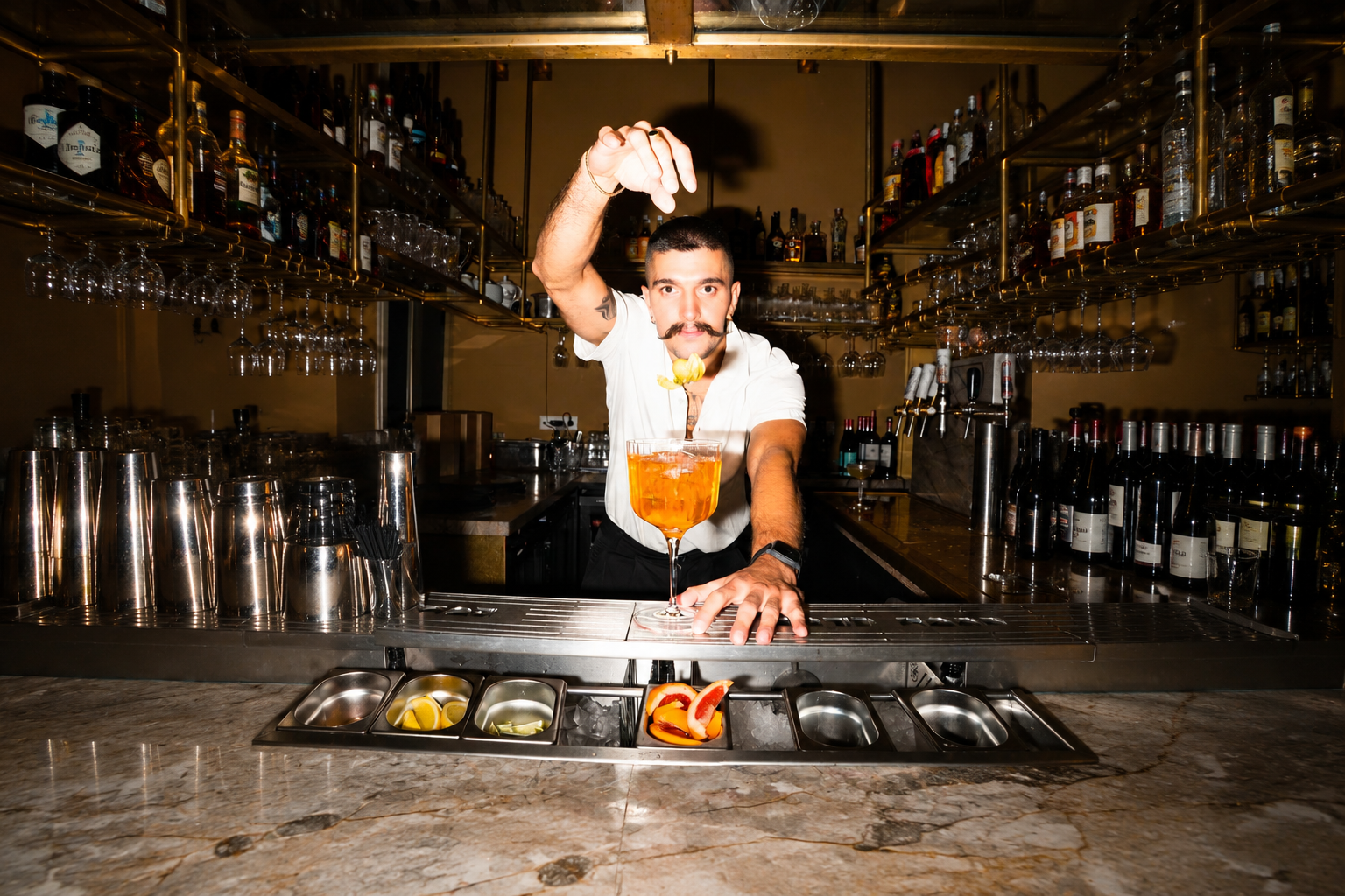 Bartender presenting an orange cocktail at a bar