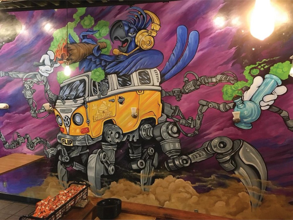 Mural of flip in a spider VW bus smoking a large blunt