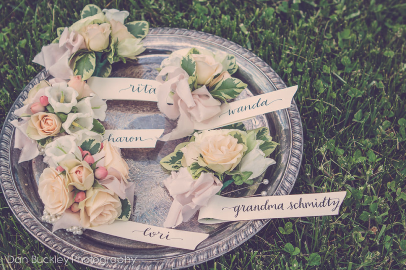 corsages of spray roses, campanula, and hyperricum berries