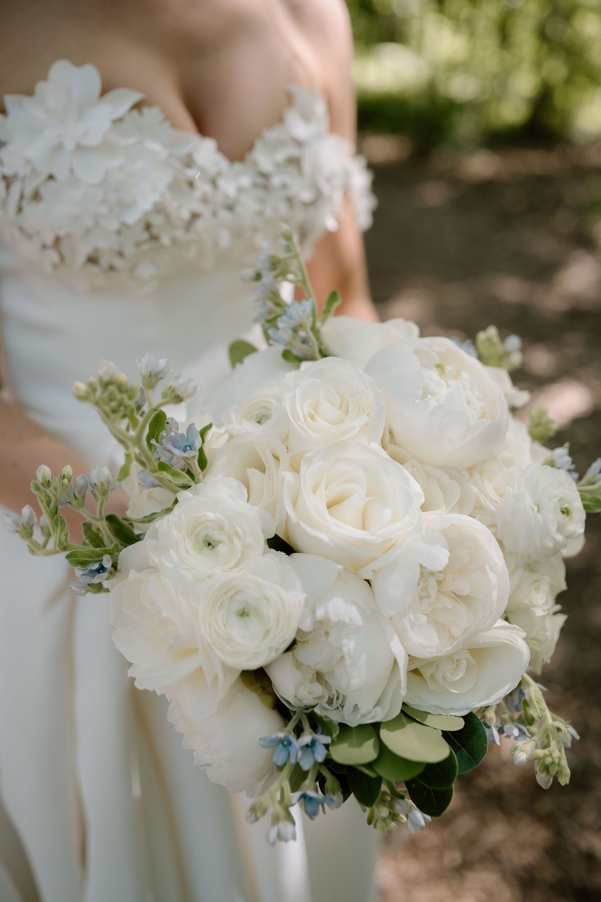 white bridal bouquet with blue tweedia