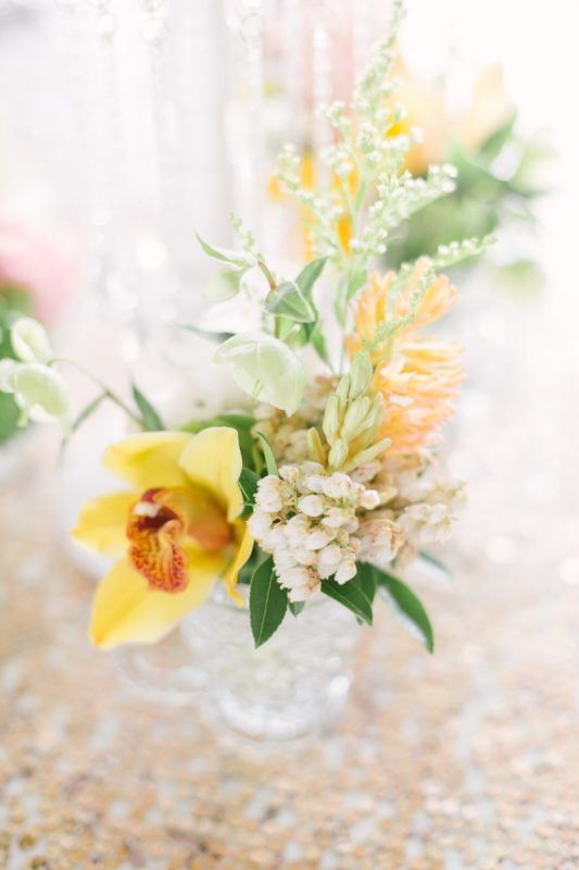 antique pressed glass tea cup of yellow orchid, pieris and hyacinth