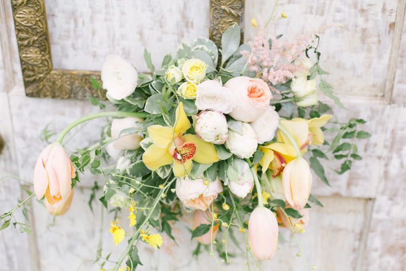 picture frame accent arrangement with peach juliet garden roses, ice cream tulips, yellow orchids, pink astilbe, peach tulips, yellow spray roses and oncibium orchids