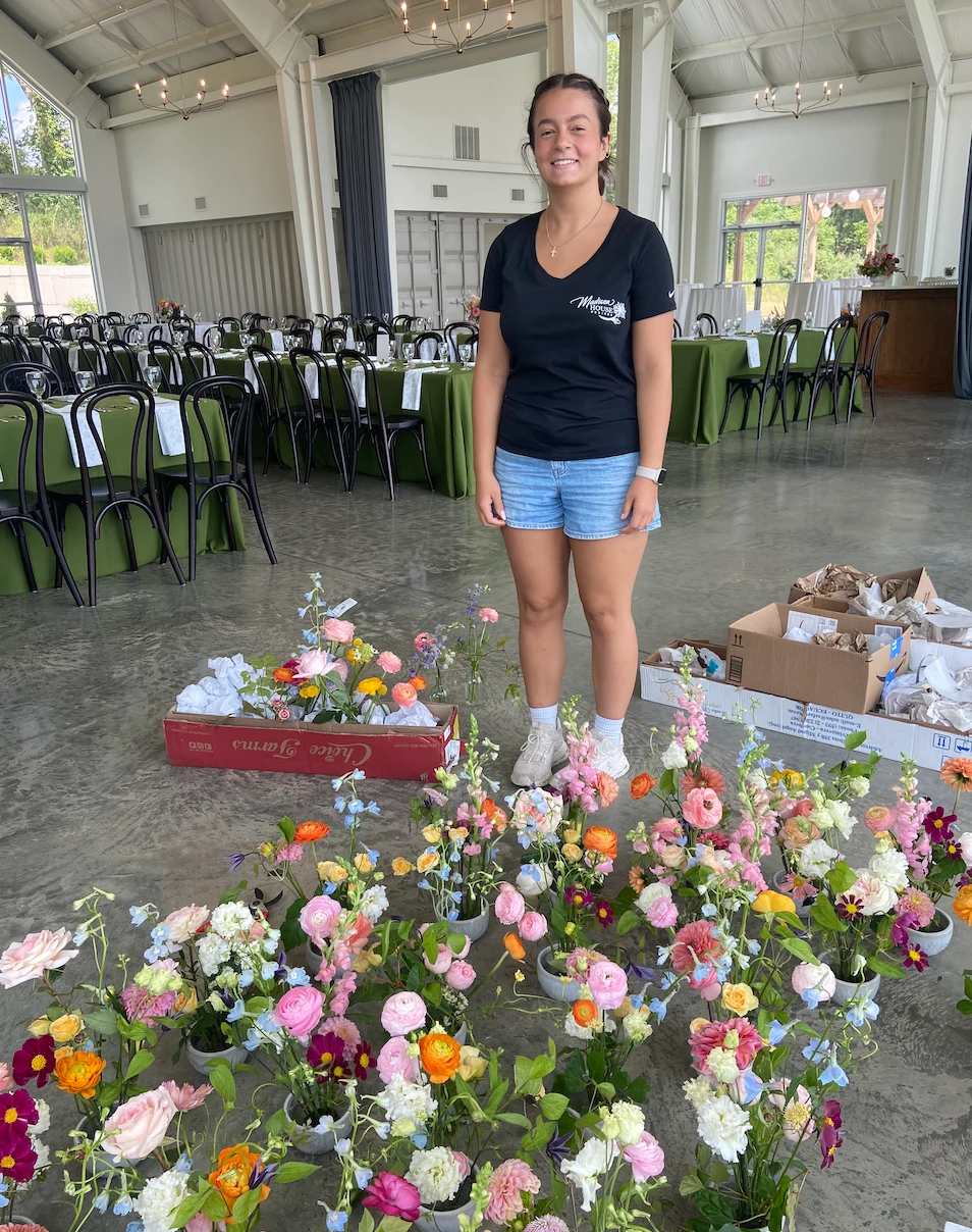 wedding florist setting up flowers at the Seventy Five Venue in Rockbridge, Ohio