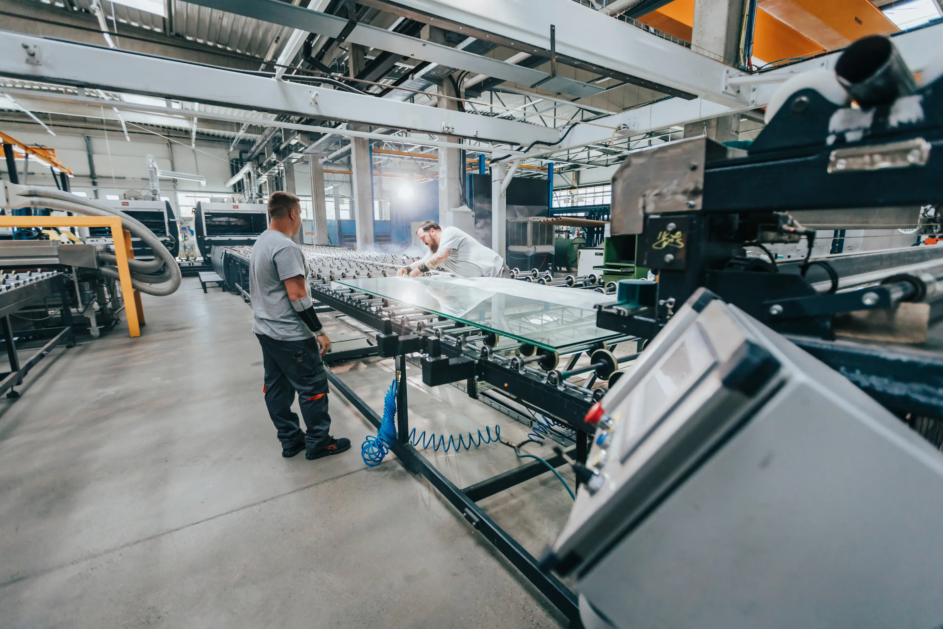 Two men work in a factory