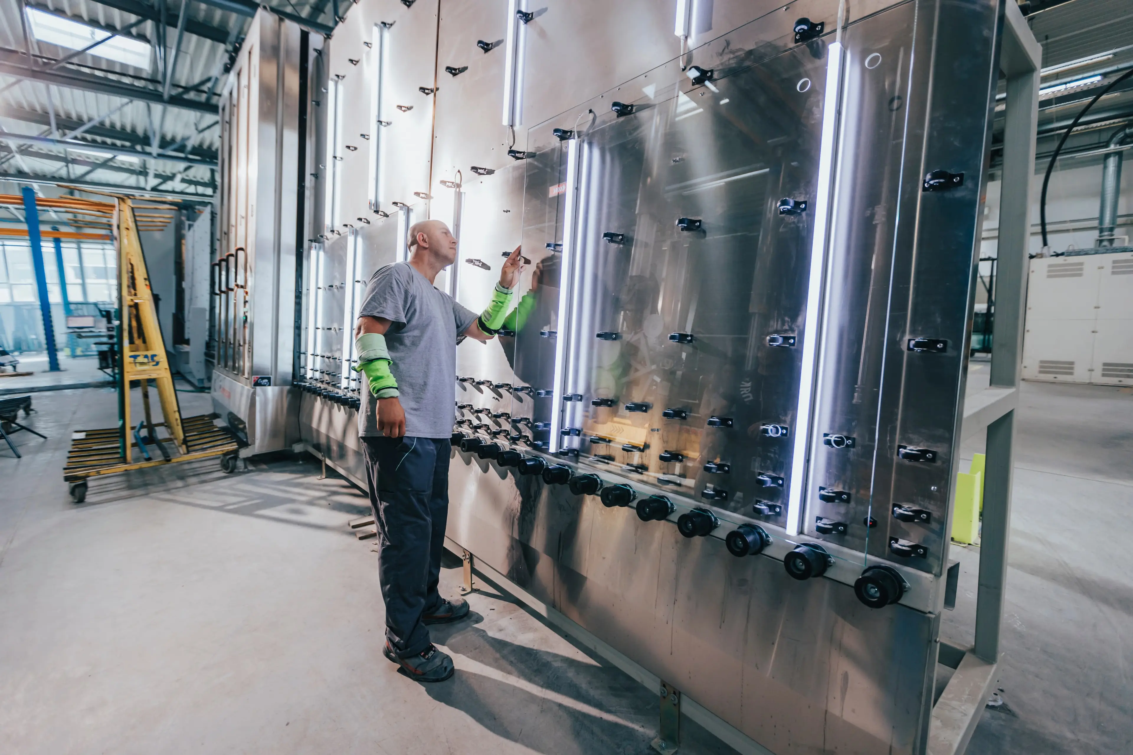 A man inspects a piece of glass