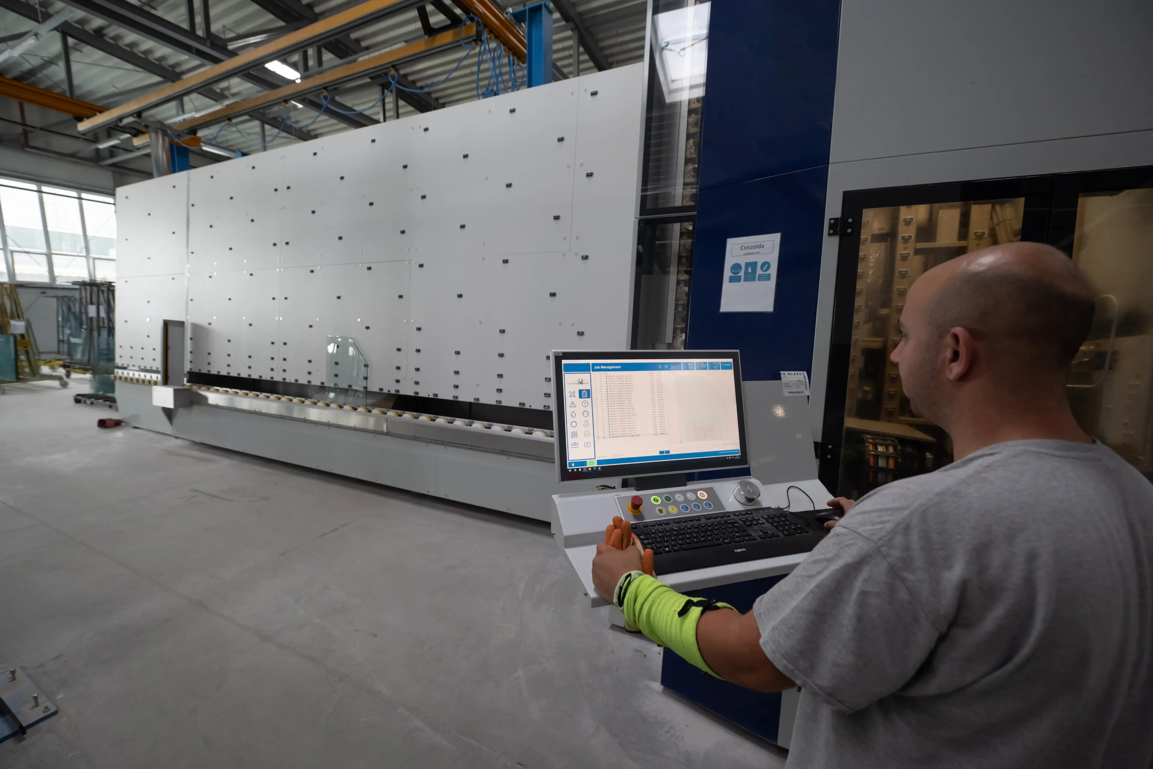 A man inspects a piece of glass