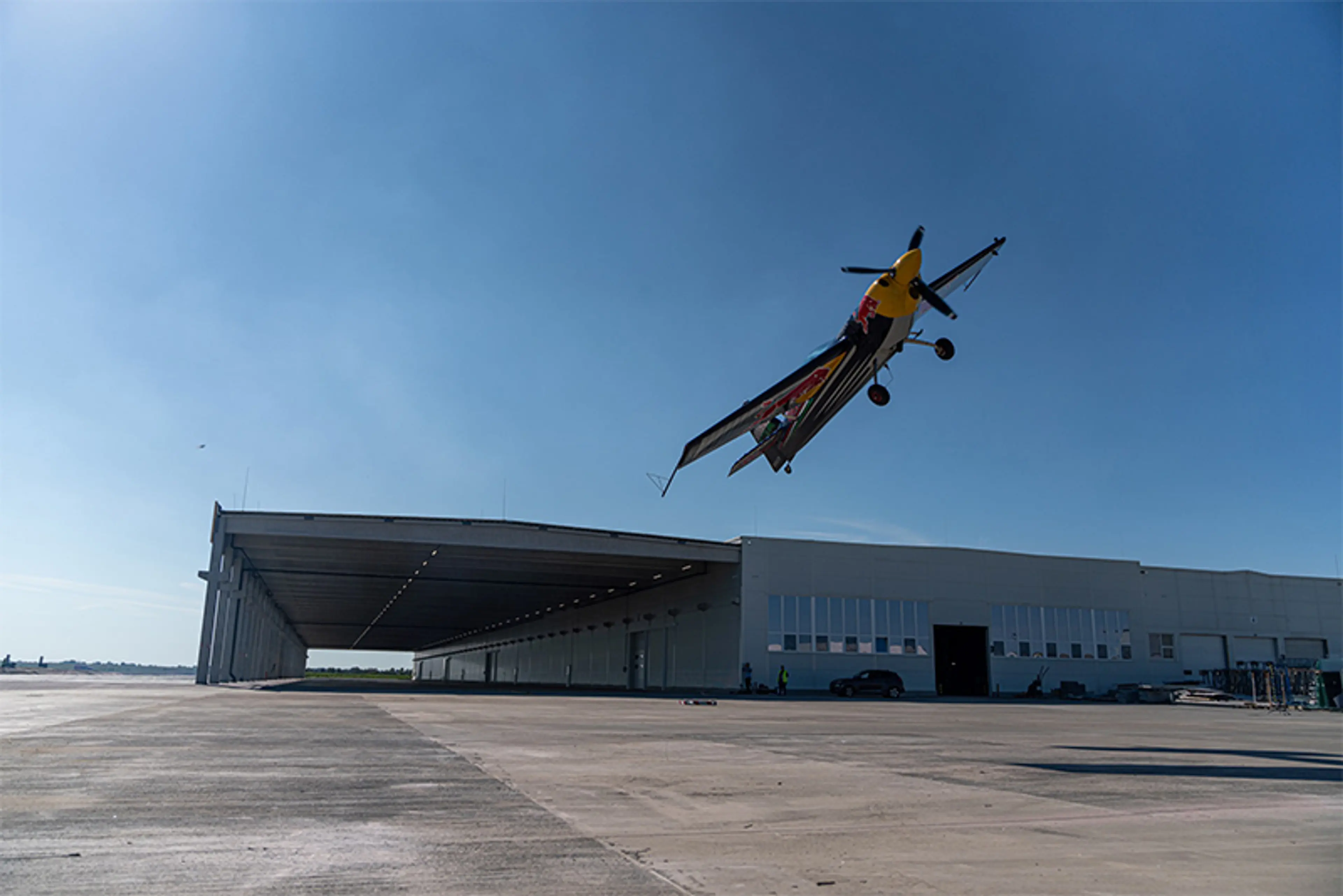 World aerobatic champion pilot Péter Besenyei flies over the new logistics hall of CE Glass