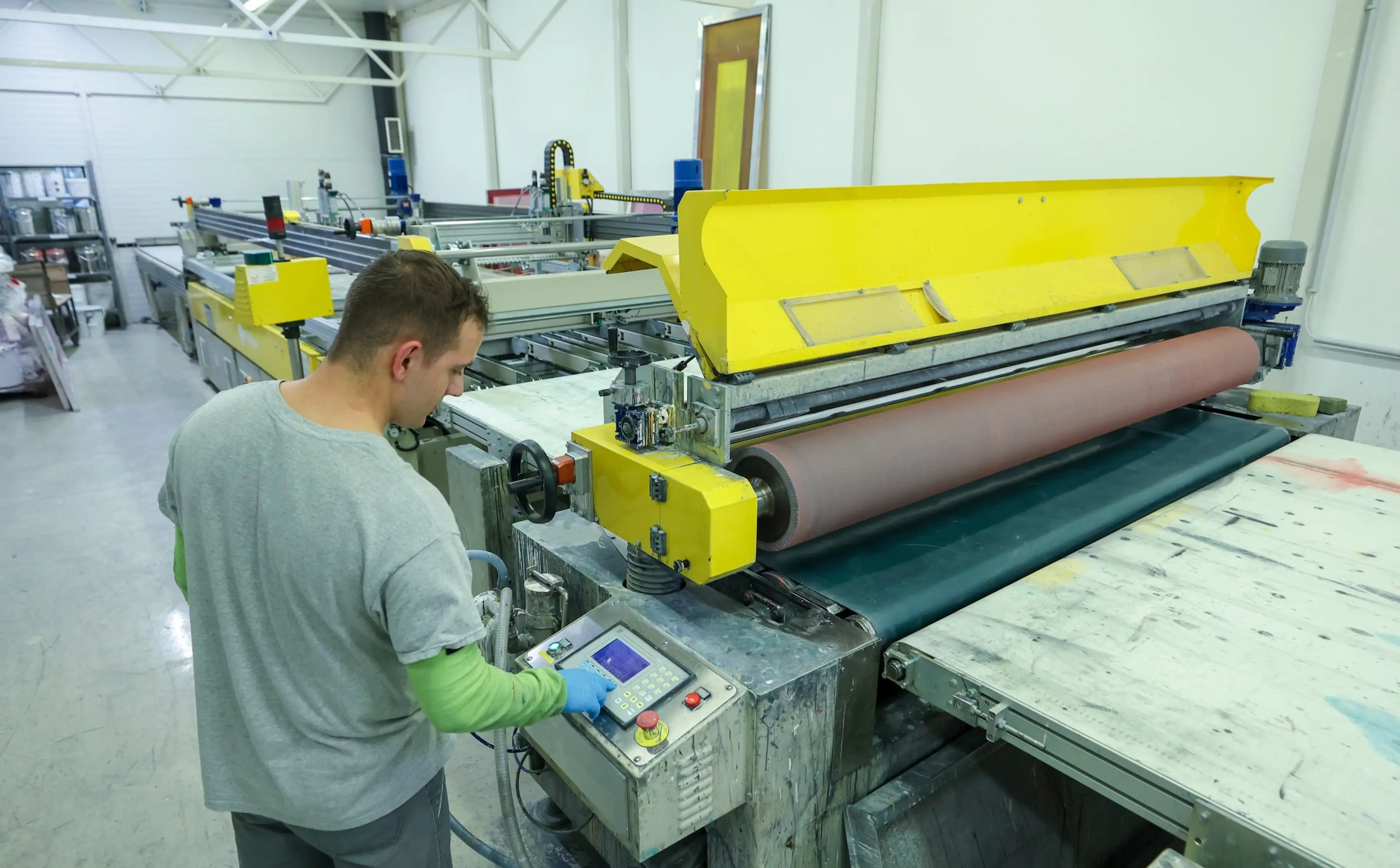 A man inspects a piece of glass