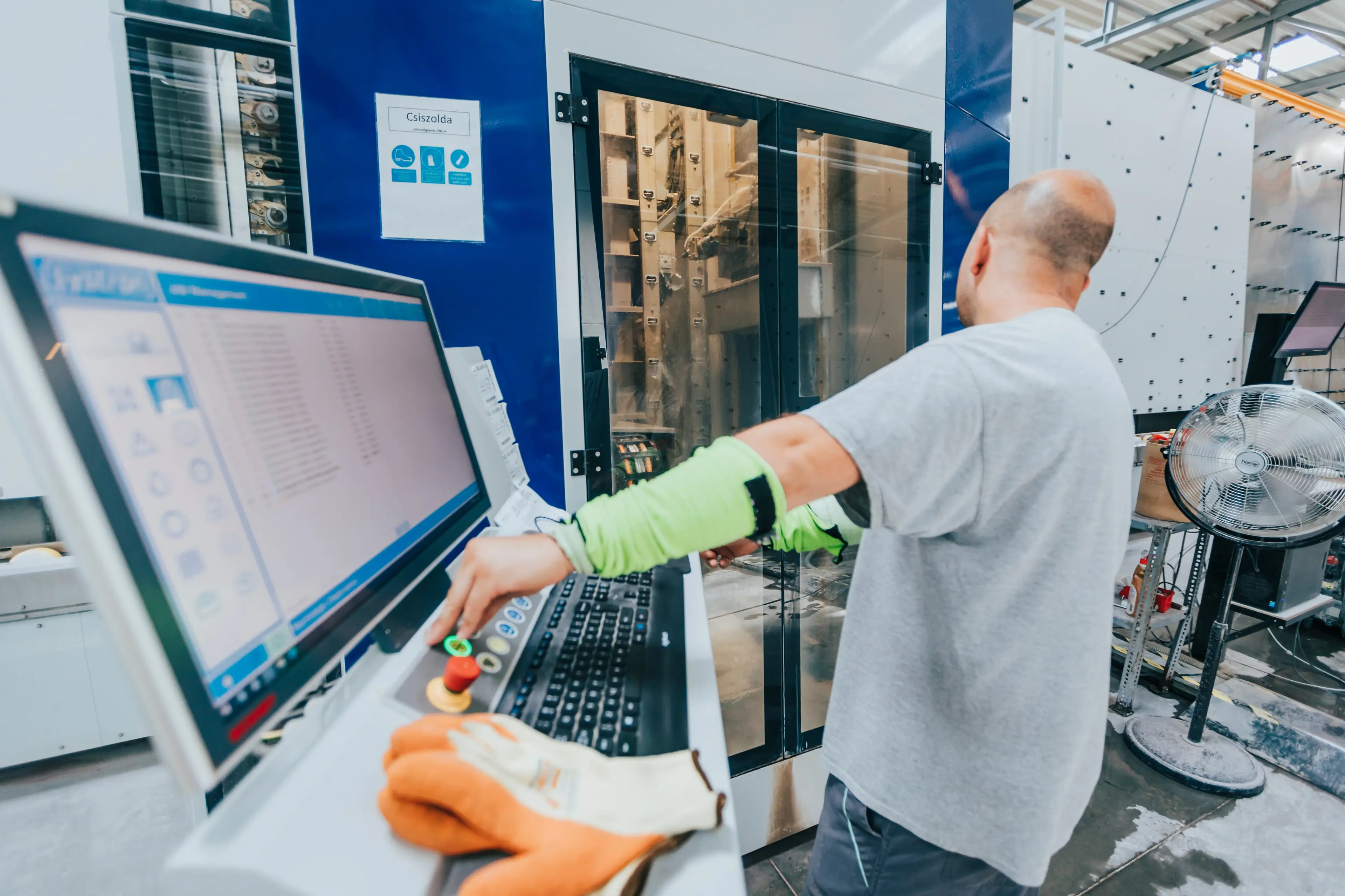 A man handling a CNC machine