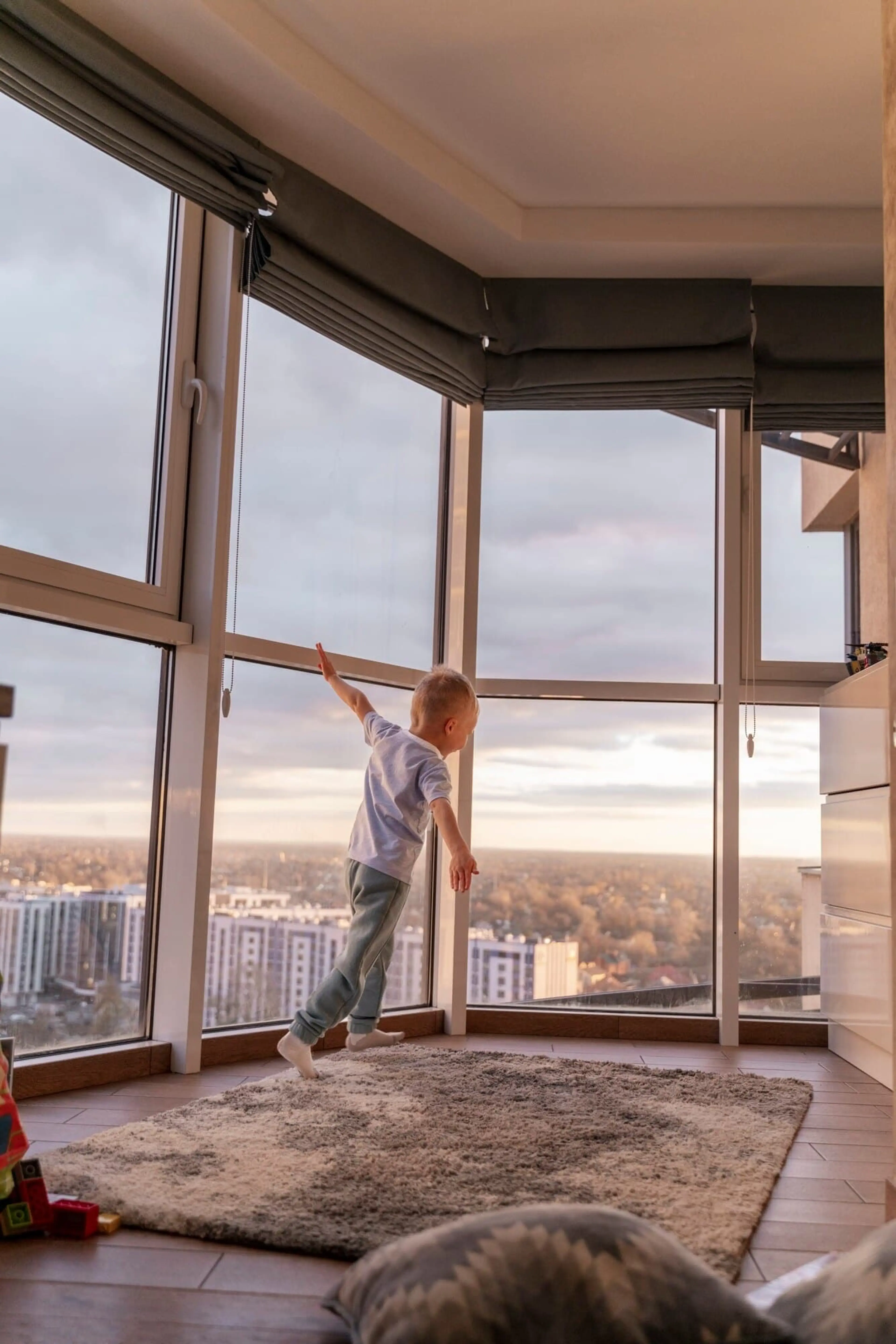 A child plays in a bright living room