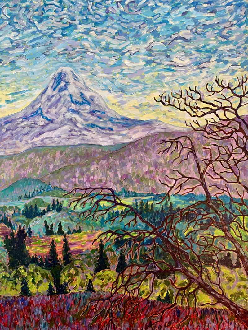 Mountain in the background with hills and trees in the middle and foreground