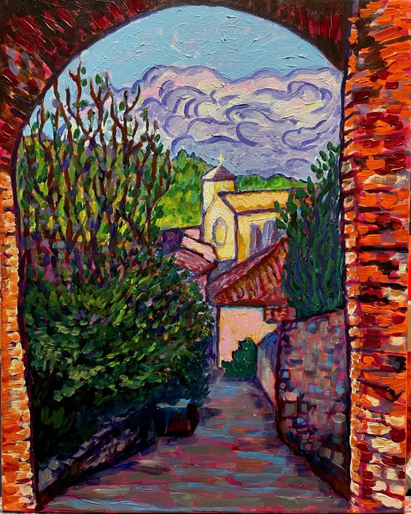 Rustic village viewed through a stone archway