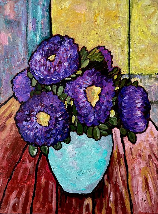 Purple flowers in a vase on a table