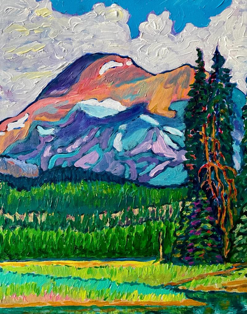 Mountain with water in the foreground and evergreen trees on the right side